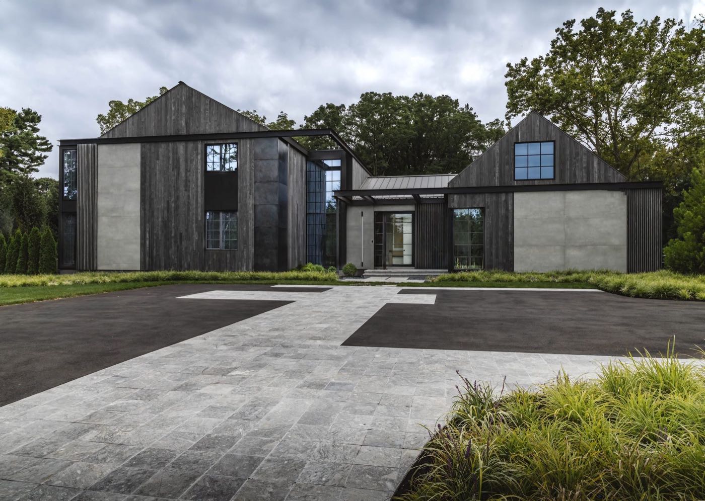 Modern home with charred timber and board-formed concrete elevation